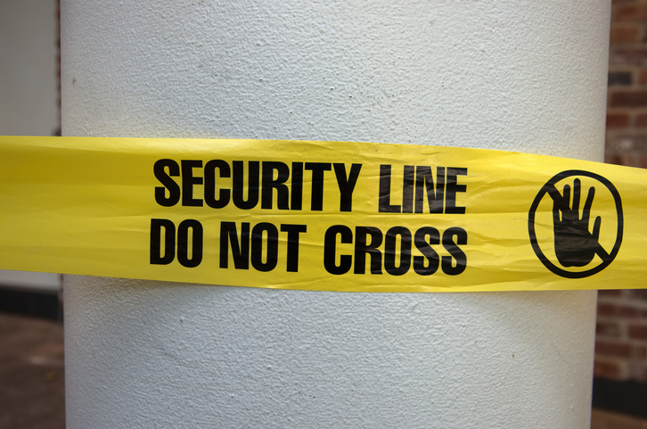 'Security line - do not cross' plastic cordon tape around a pillar
