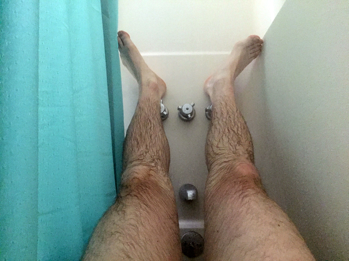 Feet resting in the shower