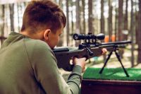 Teenager Learning How to Properly Shoot a Rifle