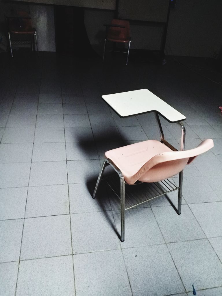 High Angle View Of Empty Chair On Tiled Floor