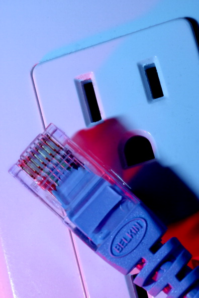 Photo illustration of ethernet cable and AC wall outlet to symbolize Internet service over power lines to home and office. (The Denver Post / Jerry Cleveland)