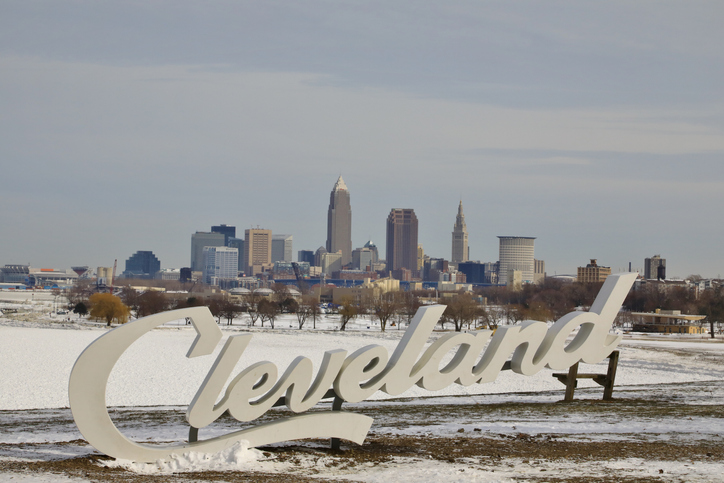 Cleveland Script tourist sign in front of the city skyline at winter season