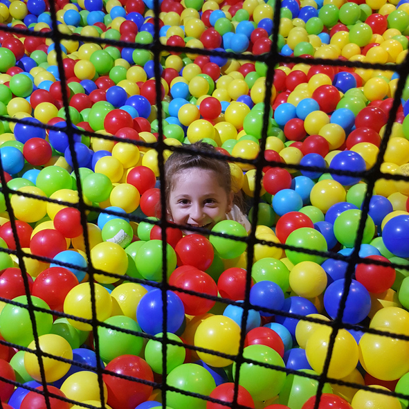 Portrait Of Smiling Girl Playing In Ball Pool