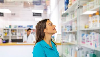 Beautiful woman shopping at pharmacy