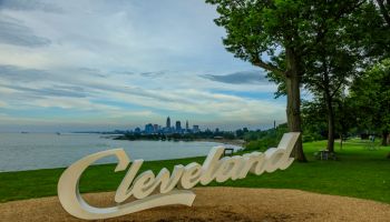 Cleveland script sign and city skyline at dusk - Edgewater Park