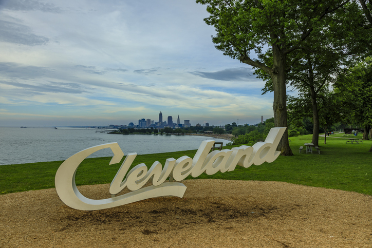 Cleveland script sign and city skyline at dusk - Edgewater Park