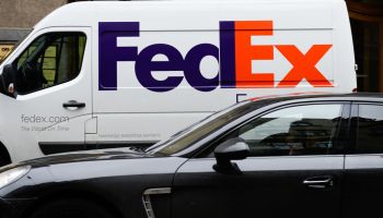 A car drives past a FedEx van in Riga...