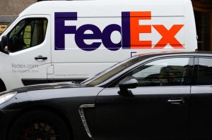 A car drives past a FedEx van in Riga...