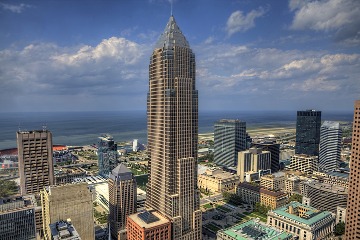 Aerial View Of Buildings In City Against Cloudy Sky