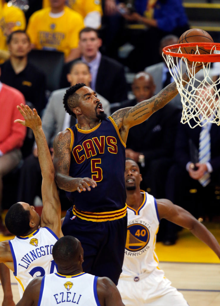 Cleveland Cavaliers' J.R. Smith (5) drives to the hoop between Golden State Warriors defenders in the first quarter of Game 2 of the NBA Finals at Oracle Arena in Oakland, Calif., on Sunday, June 7, 2015. (Nhat V. Meyer/Bay Area News Group)