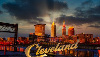 Cleveland script sign and city skyline at sunset - Flats West Bank