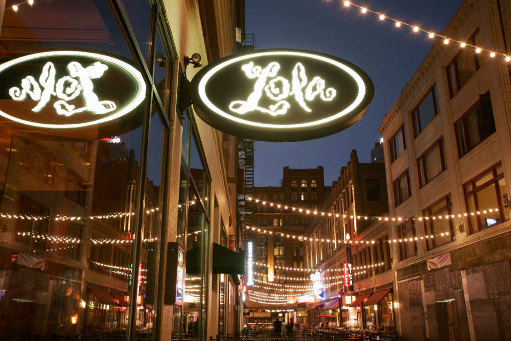 Lola Restaurant sign at night.