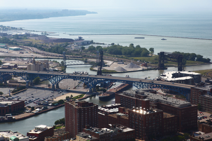 High Angle View Of City By Sea Against Sky