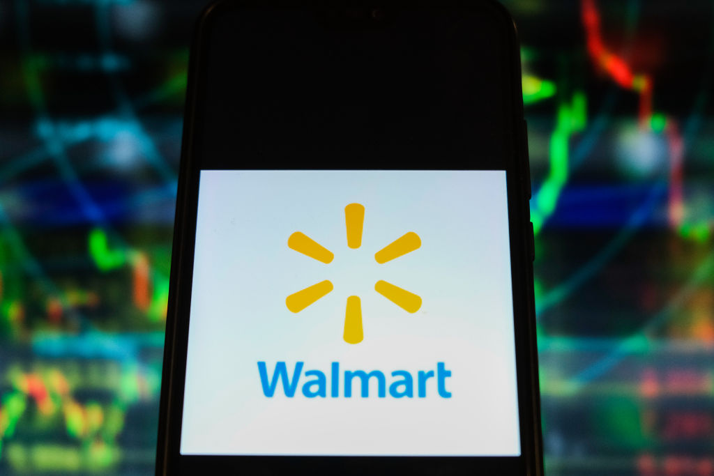 In this photo illustration a Walmart logo is displayed on a...
