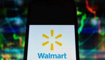 In this photo illustration a Walmart logo is displayed on a...