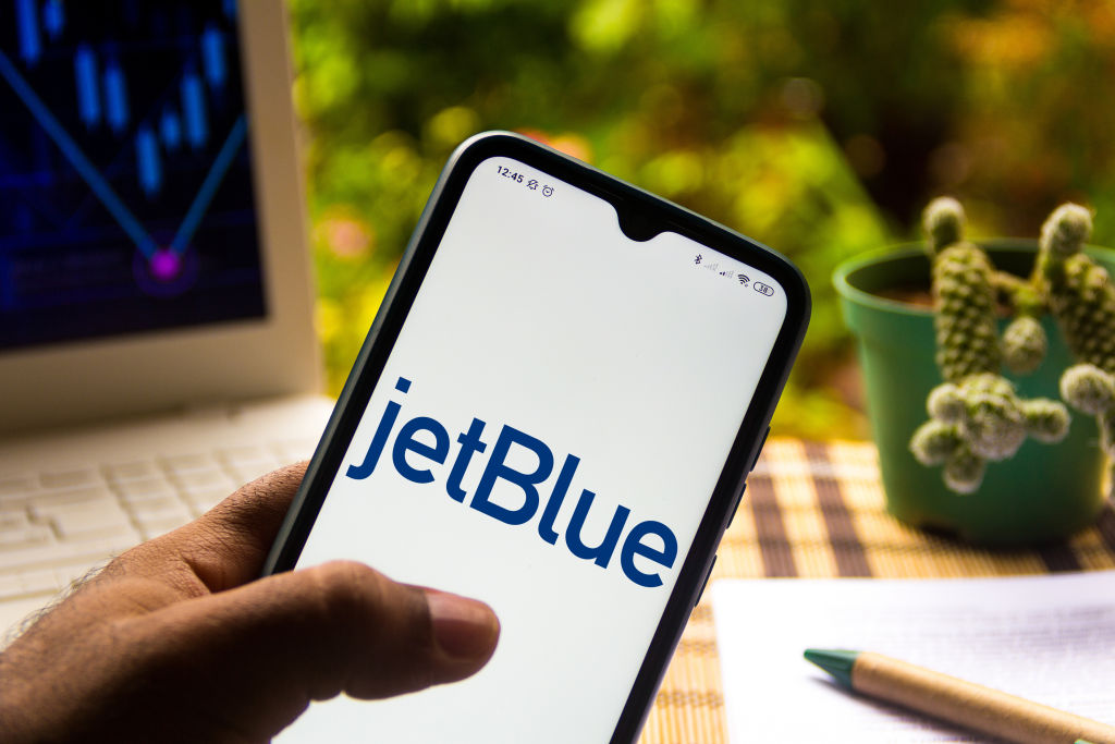 In this photo illustration the JetBlue Airways logo seen...