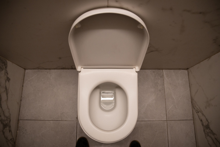 Empty white toilet bowl in a bathroom - Stock photo