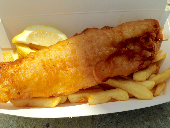 Closeup of Fish and Chips with lemon takeaway meal