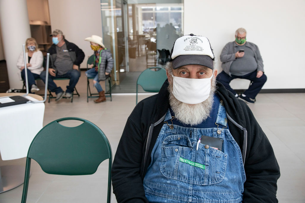 Edward Vires, 64, waits for a half hour after receiving the...