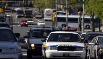 A Philadelphia police patrol car drives up 19th Street in Ph