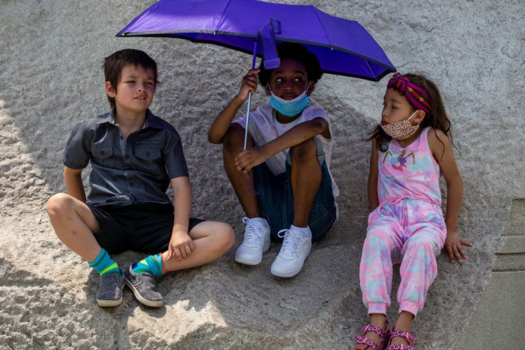 Kids play at the base of the Martin Luther King Memorial in Washington, DC