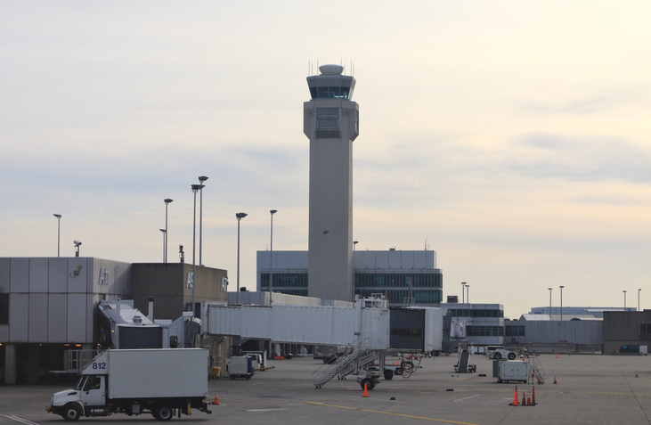Airport tower and tarmac area with passenger loading equipment