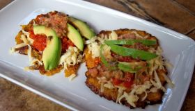 Patacones (Colombian-style fried plantains) with shredded chicken, cheese, tomato salsa and avocado