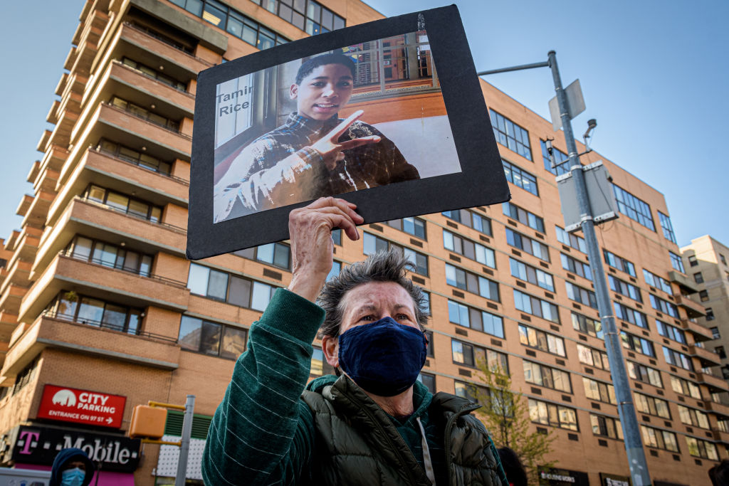 Participant seen holding a protrait of Tamir Rice at the...
