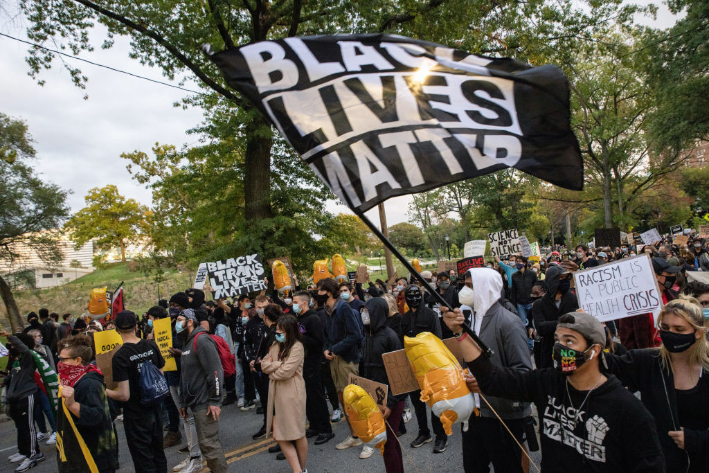 Protesters wearing masks march through University Circle...