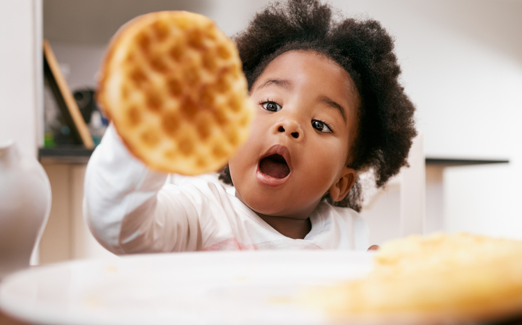 Shot of a little girl about to eat a waffle