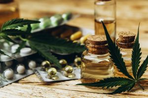 Hemp oil, cannabis leaves, cbd softgels and pills.