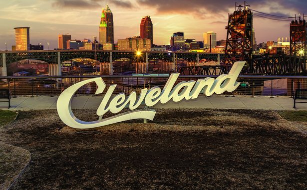 Cleveland script sign and city skyline in the evening - Tremont