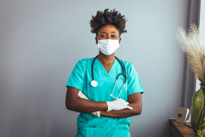 Portrait of african-american female doctor with stethoscope on hospital background.