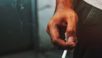 Close up male hand holding a cigarette