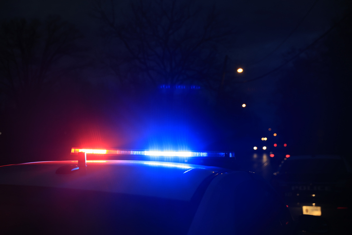 Police vehicles are parked at as police look for a person wanted on an arrest warrant in Bloomington, Indiana.