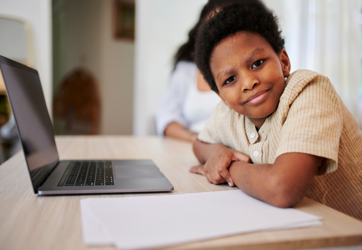 Laptop, portrait or online education with a mother and son in their home together for learning. Black family, computer or study with a woman and male child doing homework for remote school