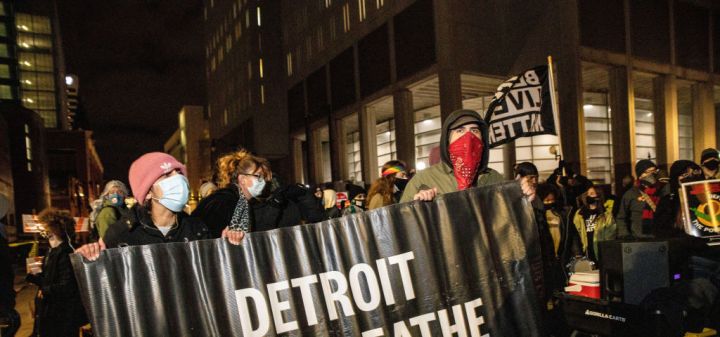 Protesters hold "Detroit Will Breathe" banner during the...