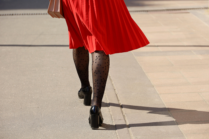 Female legs in tights and black shoes