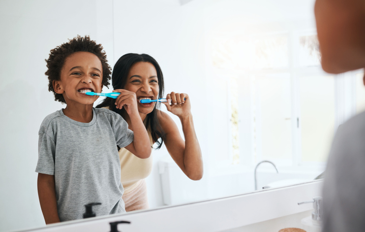 Learning, mother and son brushing teeth, dental hygiene and wellness at home, bathroom and bonding. Family, female parent or mama with male child, kid or boy with oral health, cleaning mouth or smile