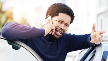 Phone call, vehicle breakdown and a frustrated black man talking to roadside assistance with an issue or problem. Car, insurance and travel with a male client speaking on his mobile in the city