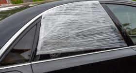 Broken car window is taped shut