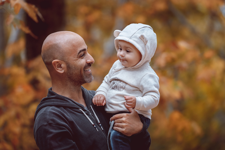Father with little son in autumn park