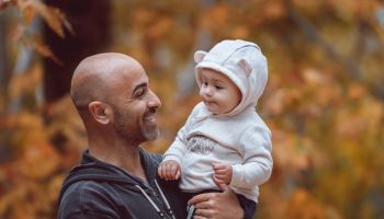 Father with little son in autumn park