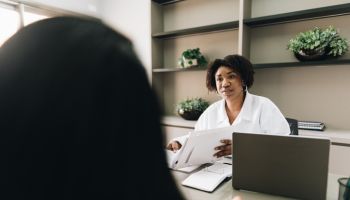 Female doctor talking with a patient on a doctor's office