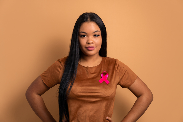 black woman wearing pink ribbon