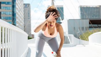 Young sportive woman feeling tired after an outdoor workout