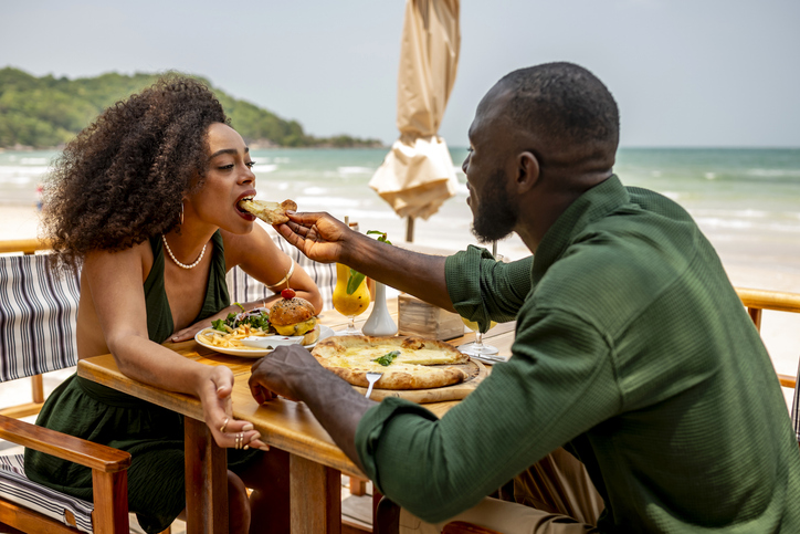 Couple Enjoying Romantic Beachside Meal at Outdoor Restaurant