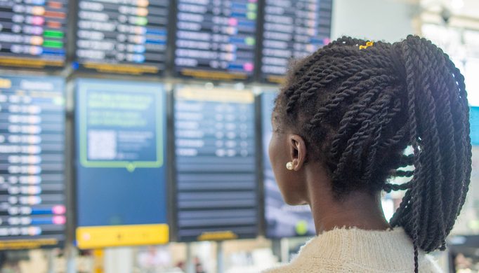 woman information screen airport