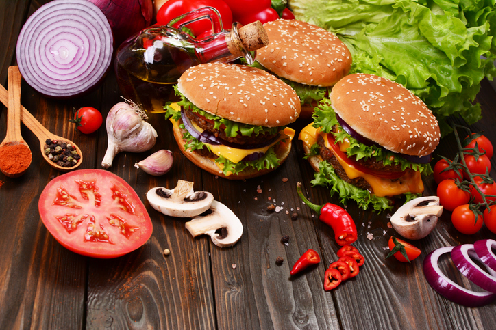 Hamburgers of the best products on a wooden background