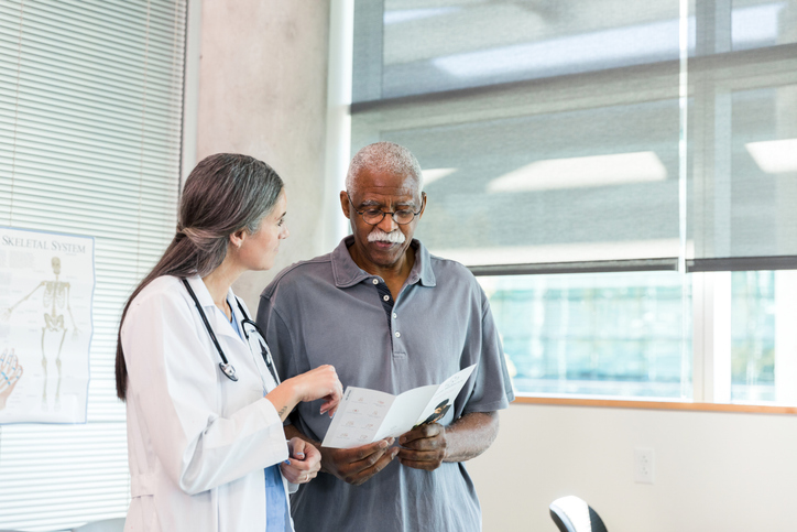 Doctor and Patient Reviewing Medical Pamphlet Together